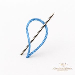 How to Start Cross-Stitching: A Beginner's Guide. 27 Cross stitch loop start method showing the needle passing through the thread loop on white Aida fabric