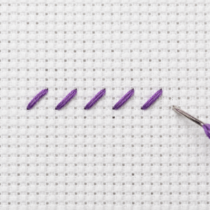 Half cross stitch on 14-count Aida with numbered stitching direction